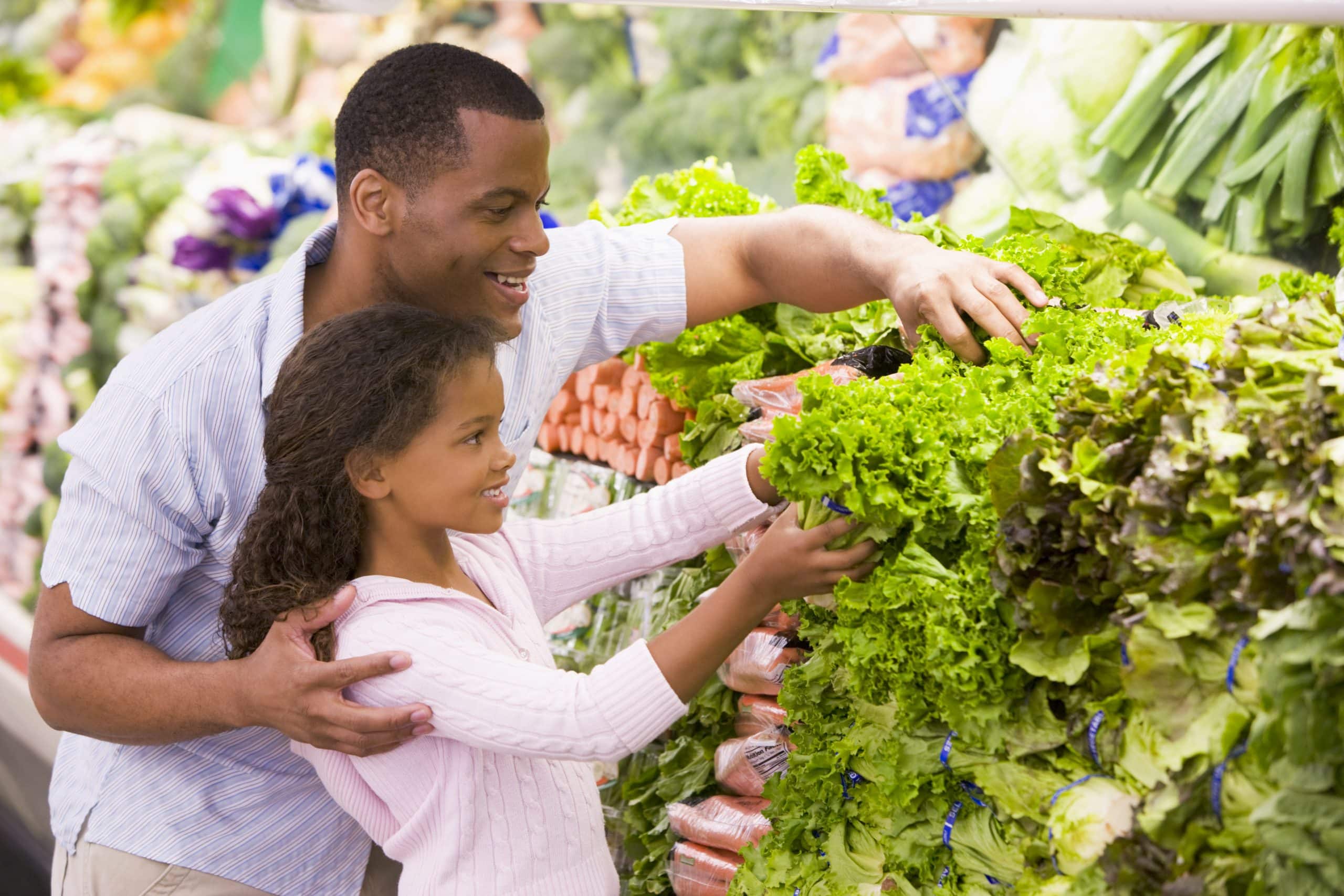 Father and daughter in produce section